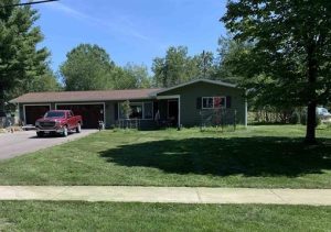 This is a photo of 11095 South Lacore in the village of Empire. It is a 4 bedroom ranch-style home with an attached three-stall garage. The backyard leads to a village park with conservancy property beyond it.