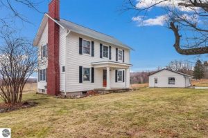 Benzonia Michigan farm for sale with an exquisitely updated farmhouse, garage, Morton pole building on 26 acres. Listed by Stapleton Realty. 231-499-2698.