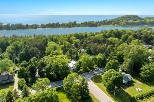 Waterfront Centennial Farm image is a drone shot taken above the farm that shows South Bar Lake and Lake Michigan beyond it.