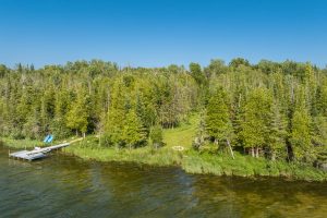 Leelanau waterfront photo is of the South Bar Lake frontage and dock that comes with this 3 bedroom centennial farmhouse and 2-acre grounds in Empire.